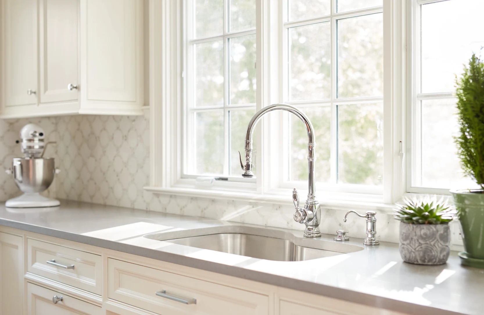 Sunlight on a kitchen sink with an easy-to-reach faucet and generous counter space